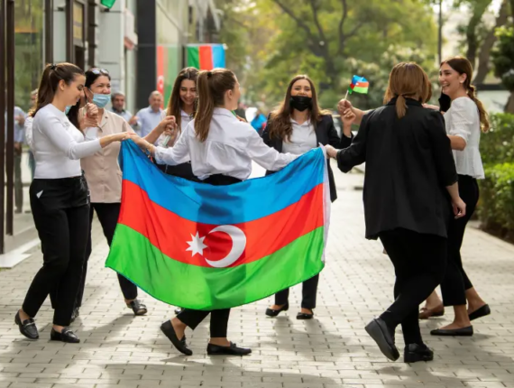 People take part in celebrations in a street following the signing of a deal to end the military conflict over the Nagorno-Karabakh region in Baku, Azerbaijan November 10, 2020 (credit: REUTERS/STRINGER)